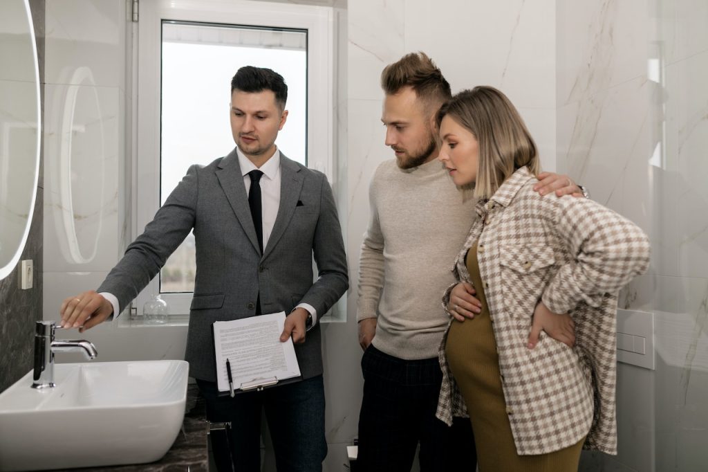 couple and agent inspecting home before moving in
