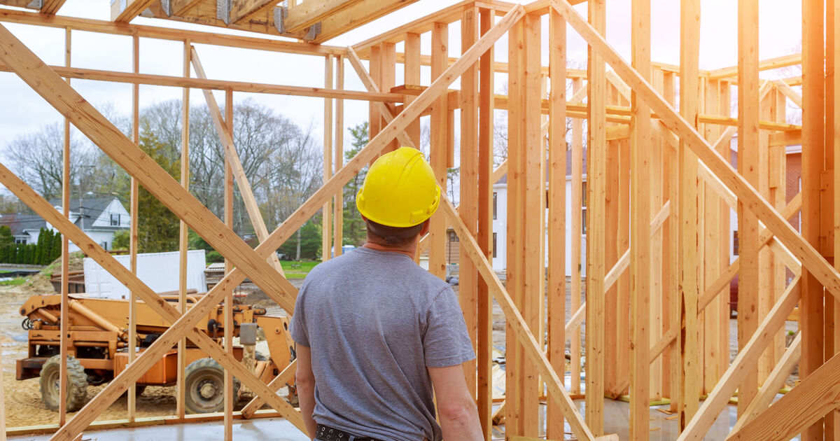 New wall framing inside a flipped house renovation before drywall