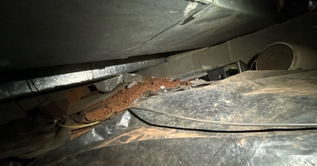 Crawl space with damaged floor joists and ductwork that a home inspection can't fully access